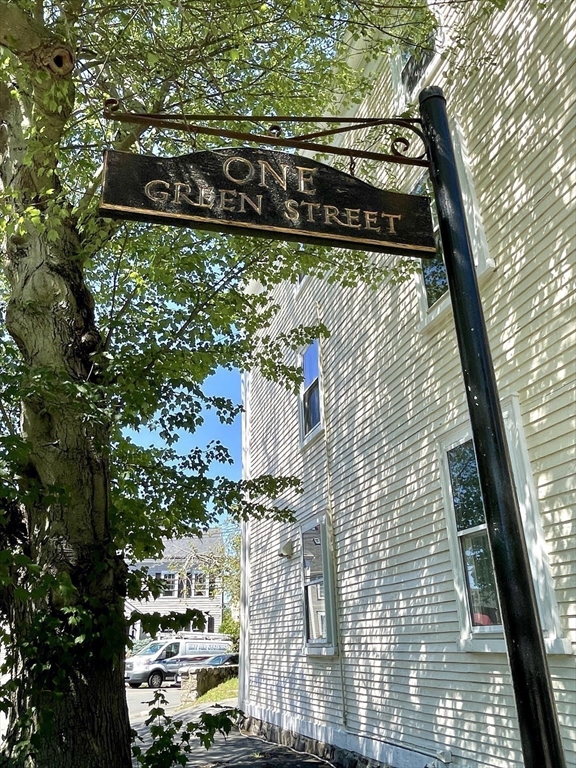 1 Green Street, Unit 2 Marblehead, MA 01945 - Photo 4 of 31 a street sign on a wall next to a building