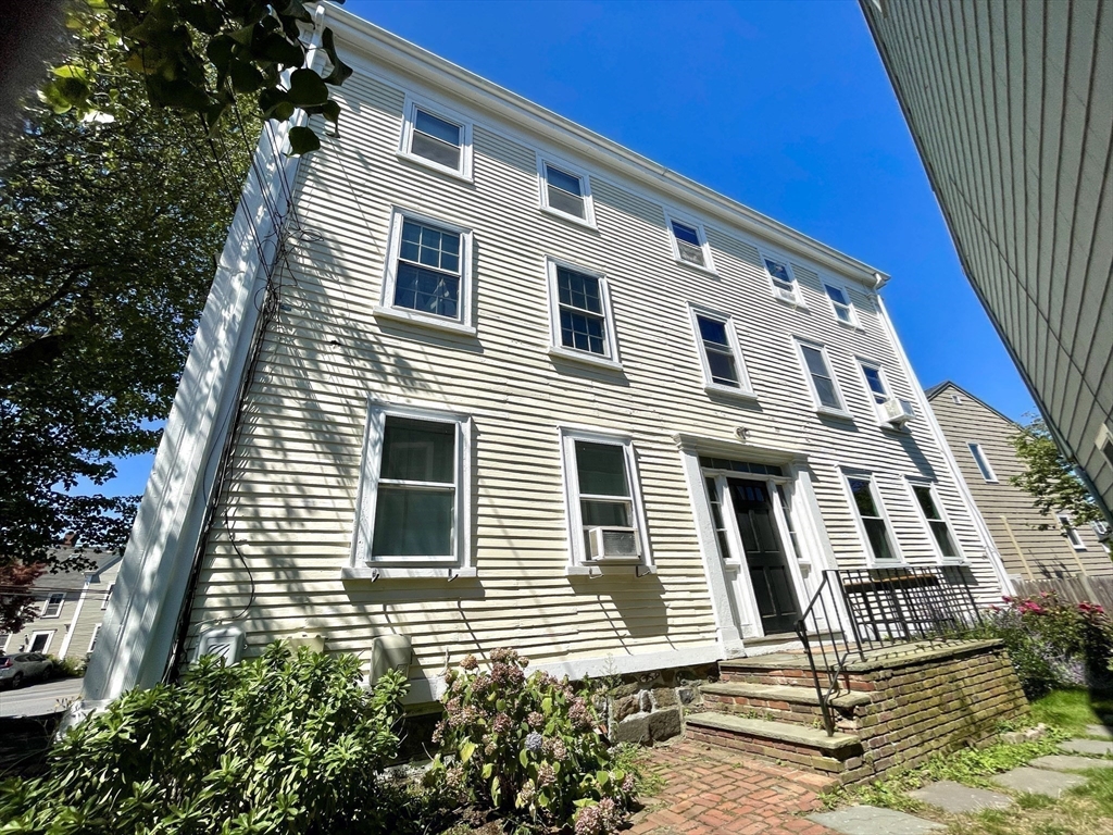 1 Green Street, Unit 2 Marblehead, MA 01945 - Photo 6 of 31 a view of a house with wooden fence