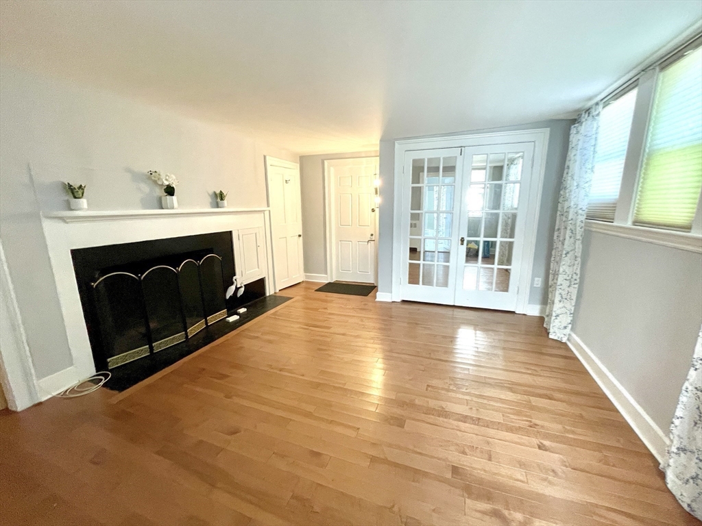 1 Green Street, Unit 2 Marblehead, MA 01945 - Photo 10 of 31 a view of empty room with wooden floor and fireplace
