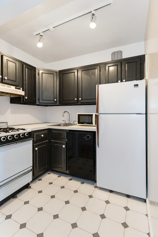 186 West 80th Street, Unit 6H Manhattan, NY 10024 - Photo 5 of 10 a kitchen with a refrigerator a stove a sink and a counter top space