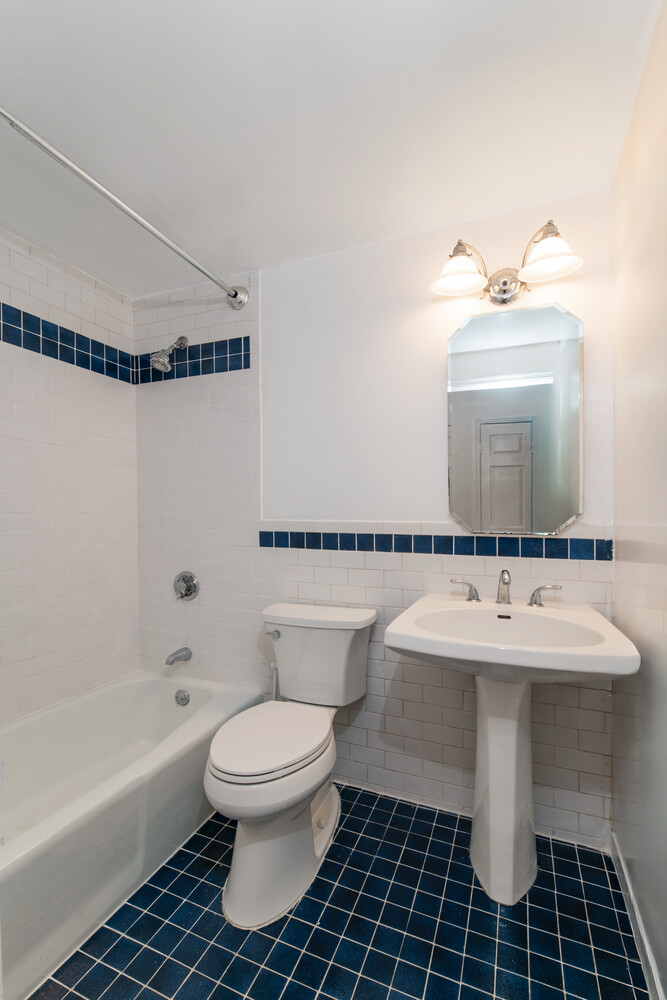186 West 80th Street, Unit 6H Manhattan, NY 10024 - Photo 6 of 10 a bathroom with a sink toilet a mirror and bathtub