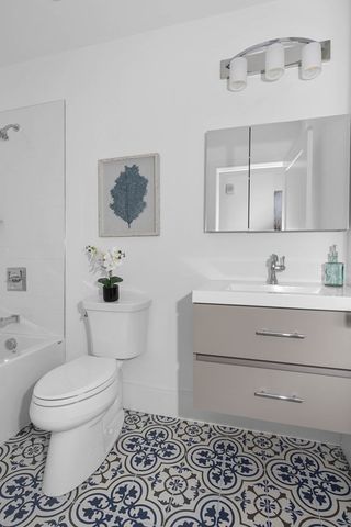 a bathroom with a toilet sink and mirror