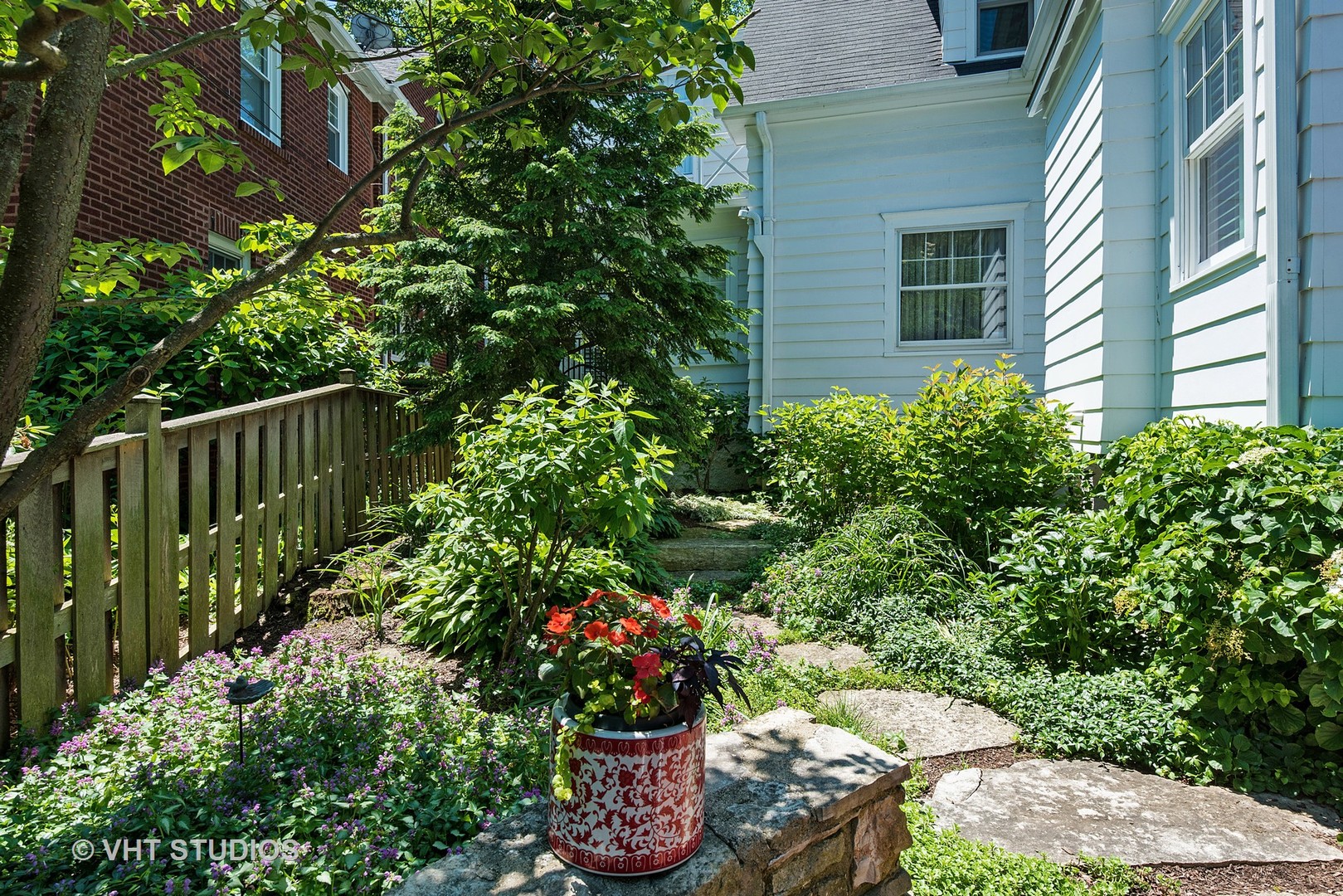 67 Warwick Road Winnetka, IL 60093 - Photo 22 of 27 a bunch of flowers are in front of a house