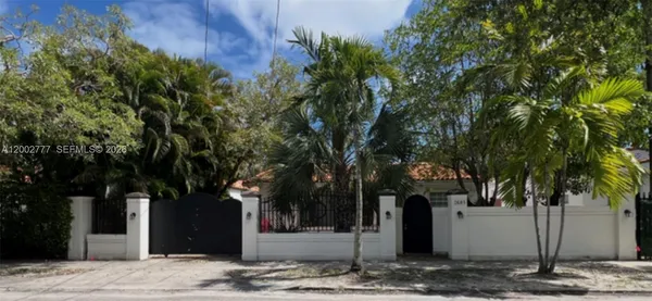 a front view of a house with trees