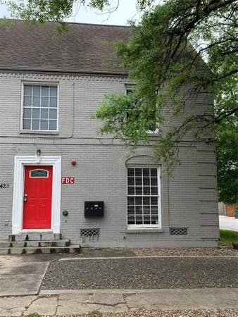 a front view of a house with garage and parking