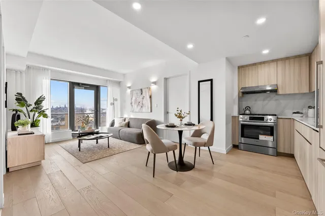 a living room with furniture a dining table and a large window