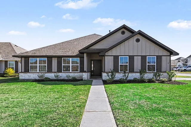 a front view of a house with a yard and porch