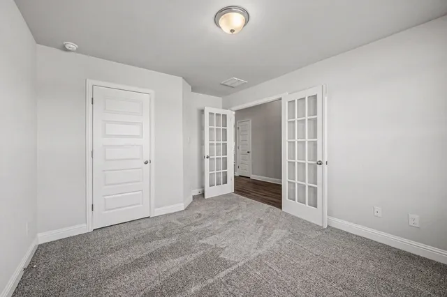 an empty room with a window and closet