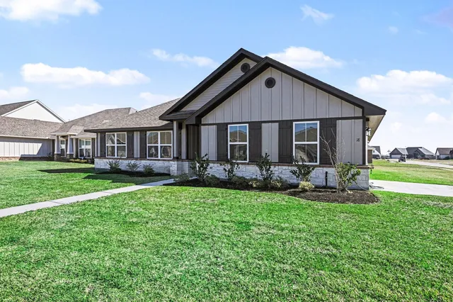 a front view of a house with garden and porch
