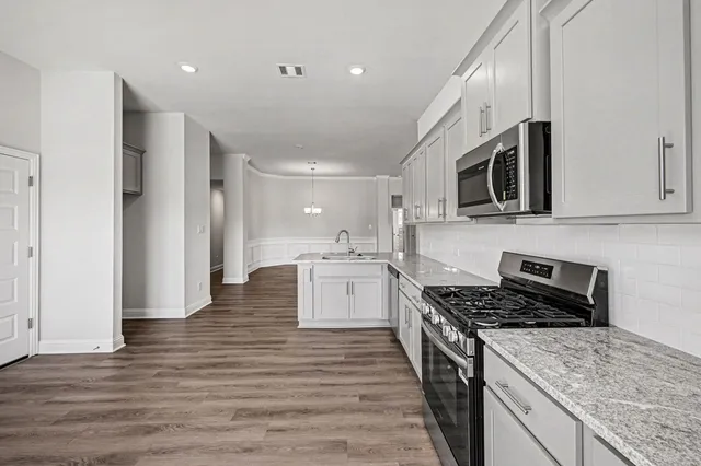 a kitchen with a stove and a microwave