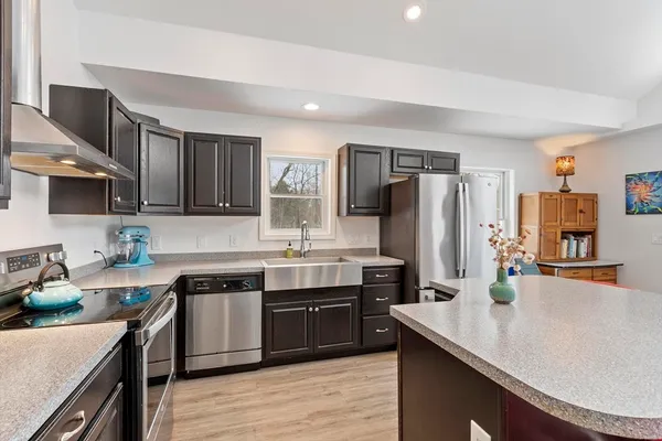 a kitchen with stainless steel appliances a sink stove and cabinets