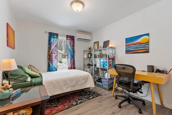 a bedroom that has a bed and a chair in it