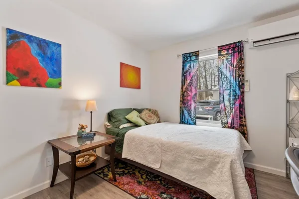 a bedroom with a bed and a bookshelf