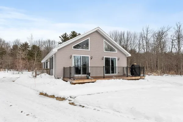 a view of a house with snow on the road