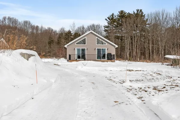 a view of a house with a snow in the yard