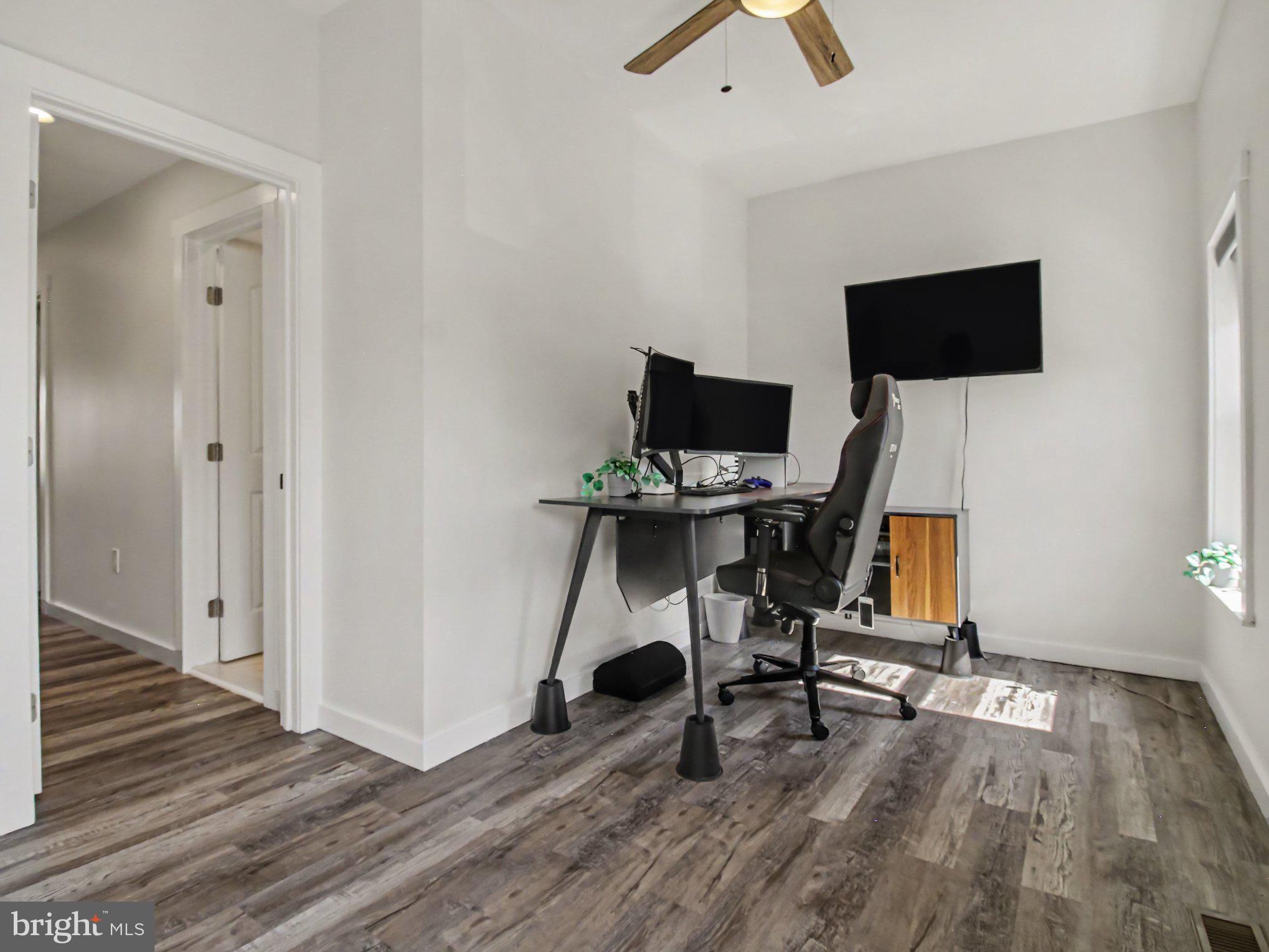 3915 Roland Avenue Baltimore, MD 21211 - Photo 17 of 26 a view of a workspace with wooden floor and white cabinet