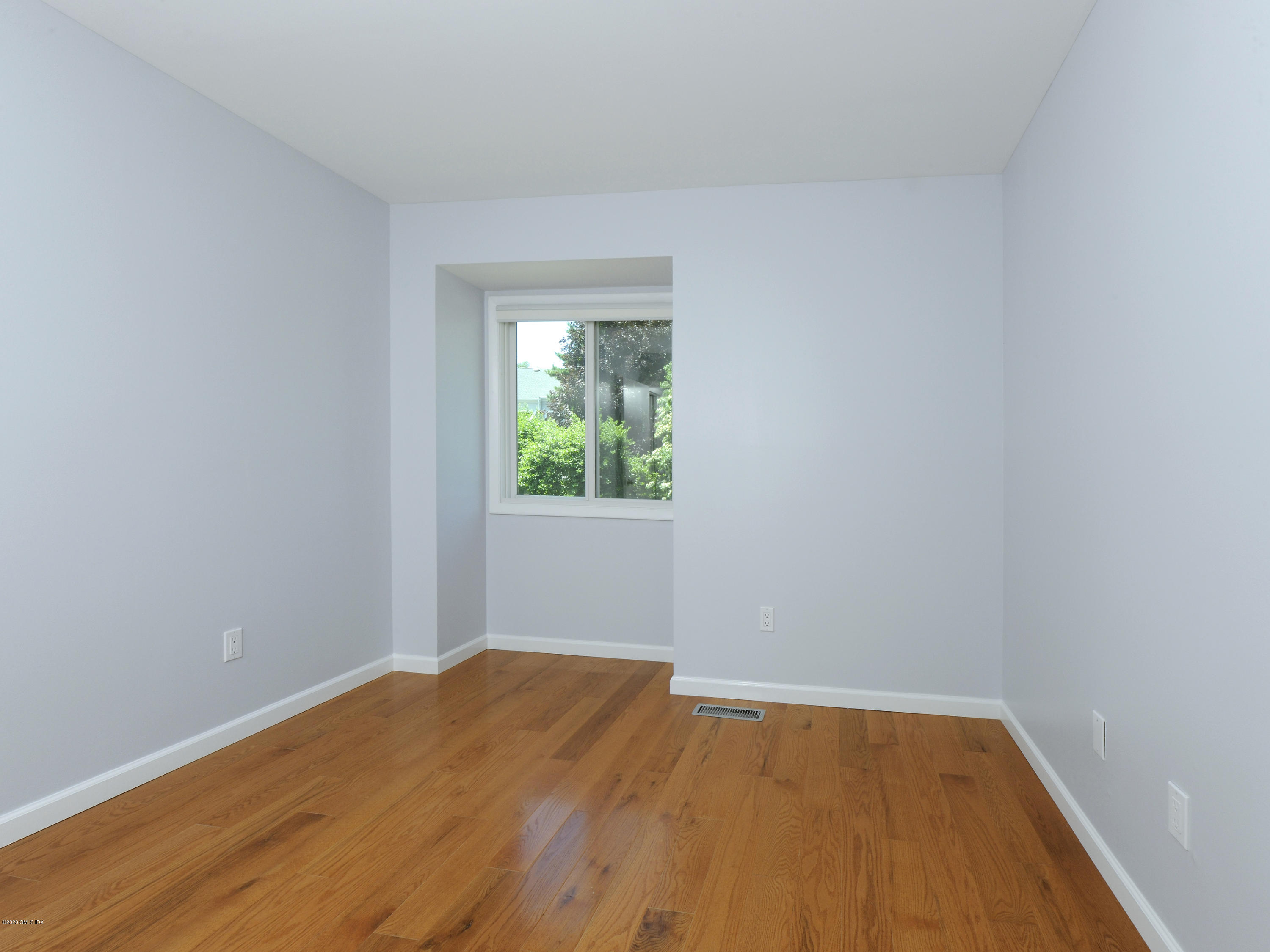 78 Silo Circle Riverside, CT 06878 - Photo 14 of 27 a view of an empty room with wooden floor and a window