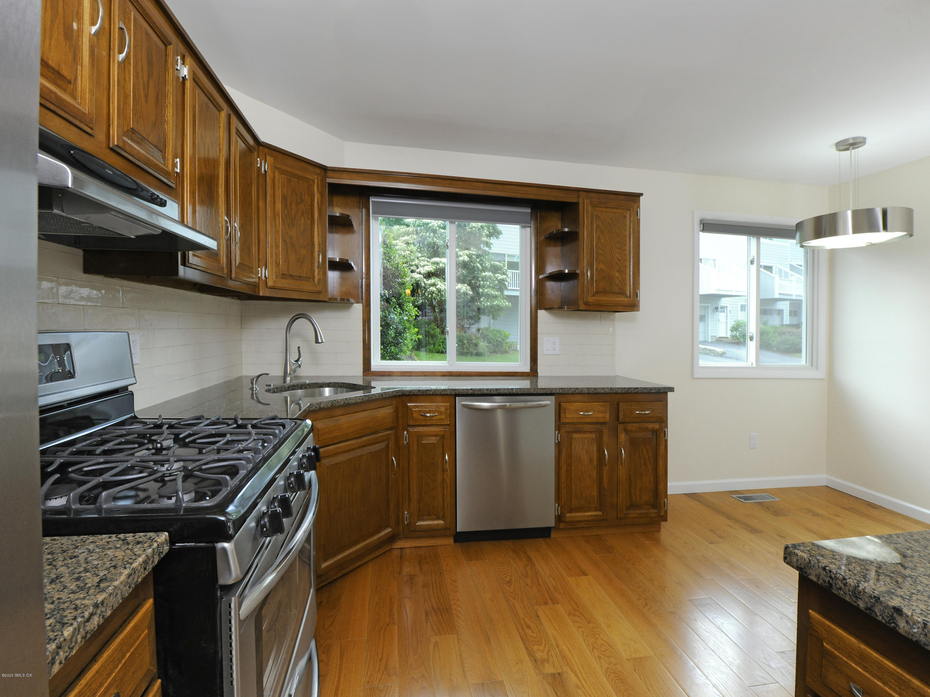 78 Silo Circle Riverside, CT 06878 - Photo 5 of 27 a kitchen with stainless steel appliances granite countertop a stove a sink and a microwave