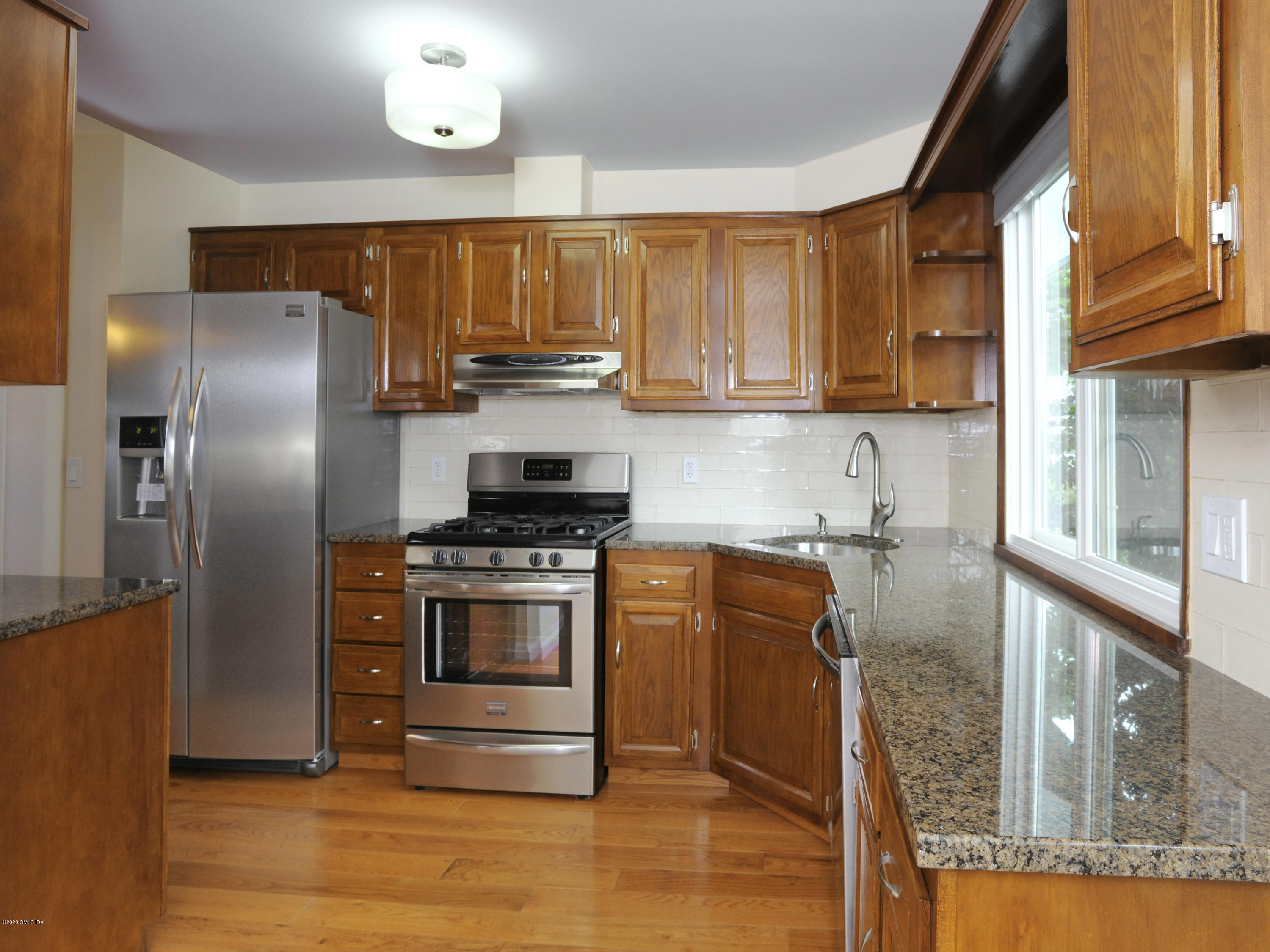78 Silo Circle Riverside, CT 06878 - Photo 6 of 27 a kitchen with stainless steel appliances granite countertop a refrigerator a stove and a sink
