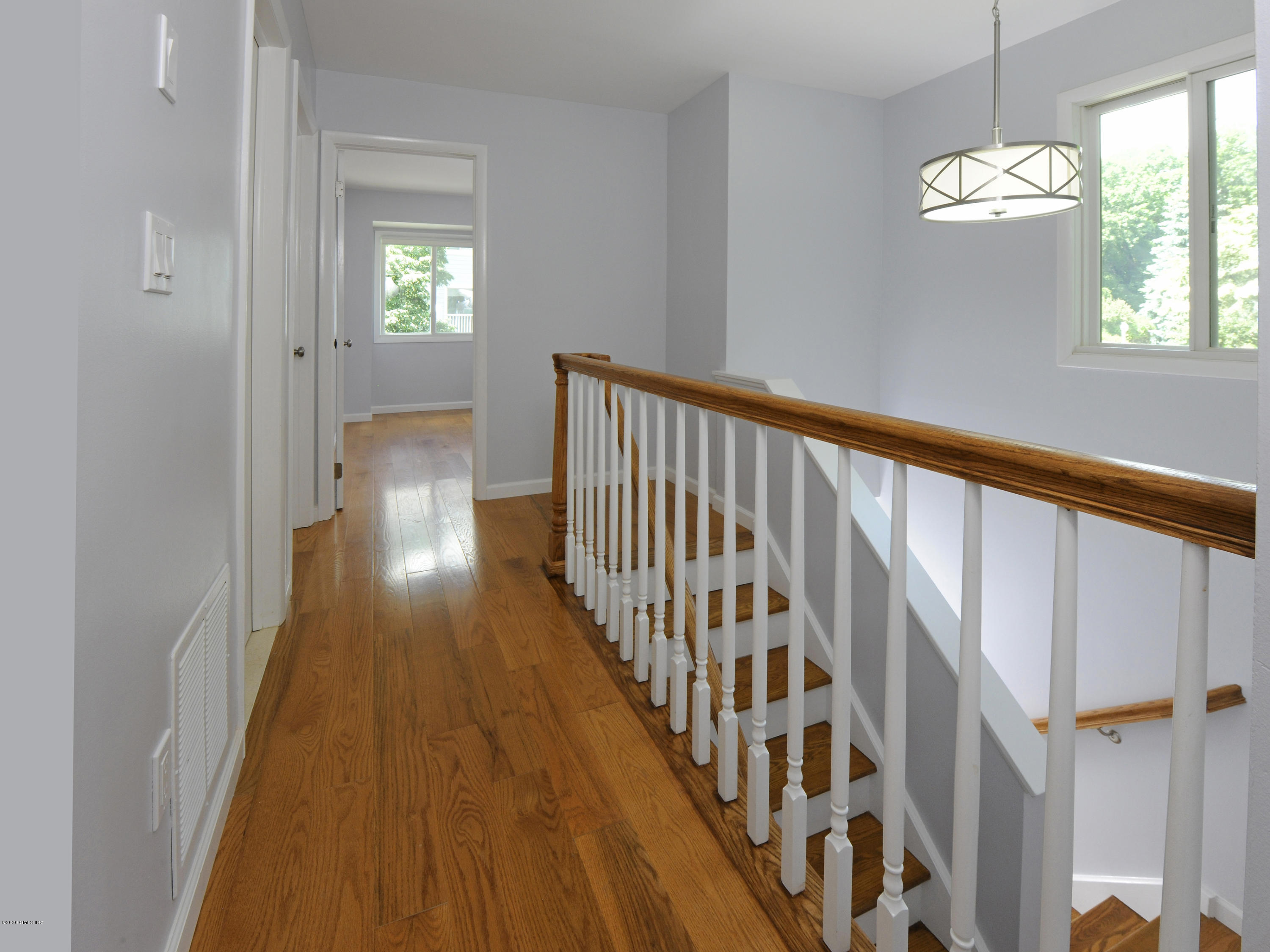 78 Silo Circle Riverside, CT 06878 - Photo 9 of 27 a view of a hallway with wooden floor and staircase