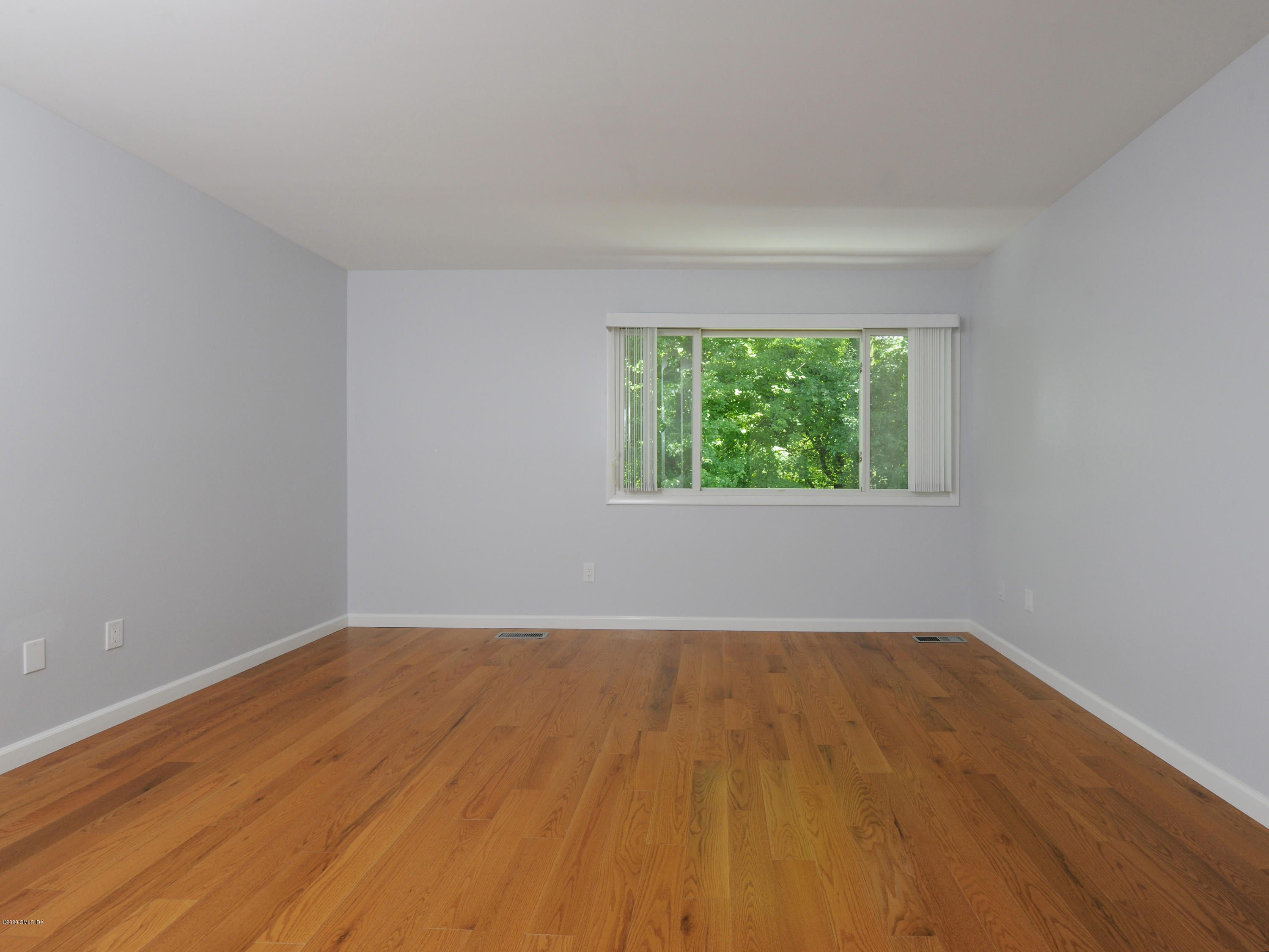78 Silo Circle Riverside, CT 06878 - Photo 10 of 27 a view of an empty room with wooden floor and a window