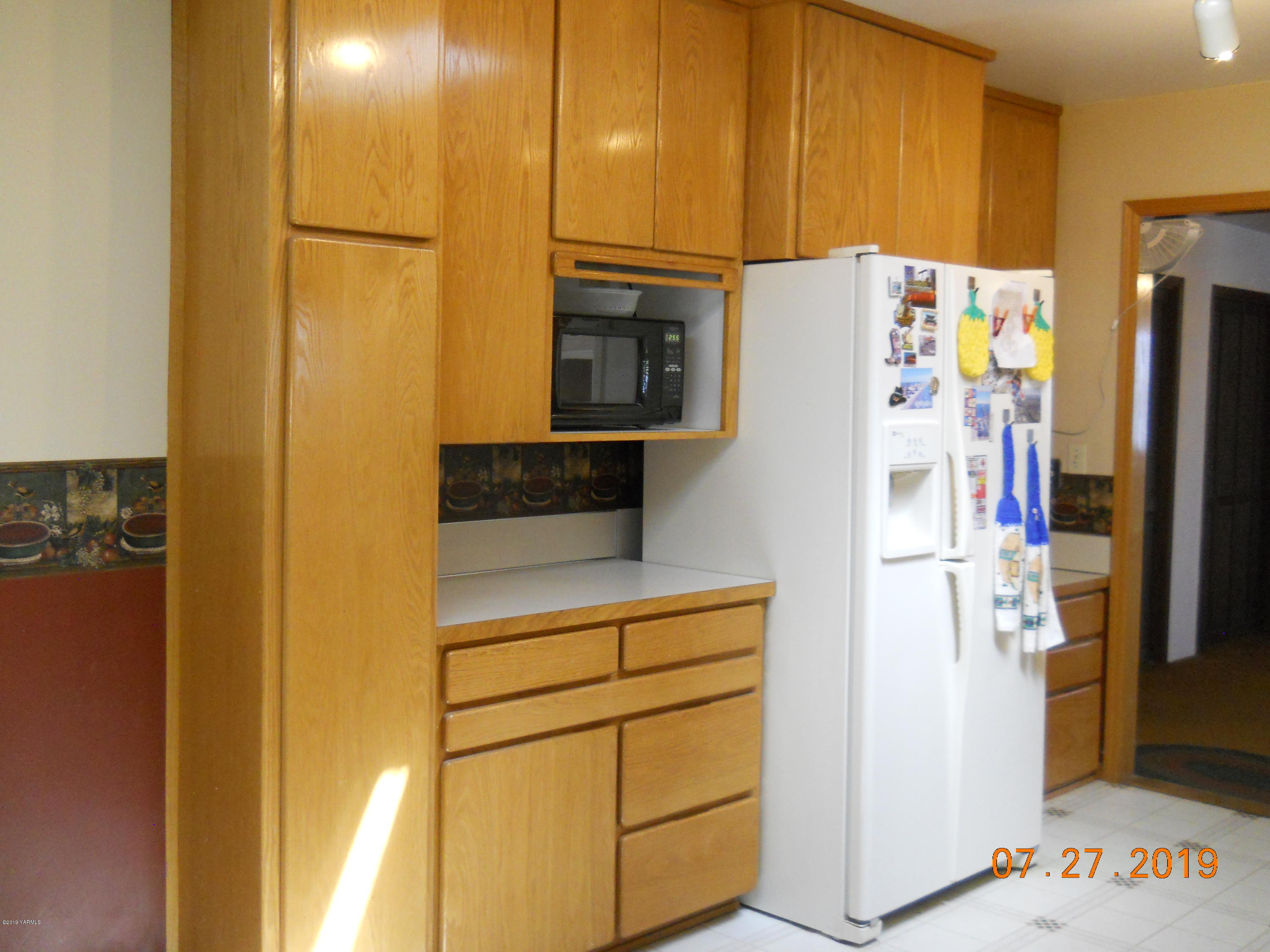 221 Rader Road Sunnyside, WA 98944 - Photo 3 of 13 a white refrigerator freezer sitting in a kitchen