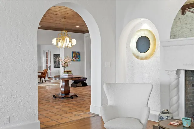 a living room with furniture and a chandelier