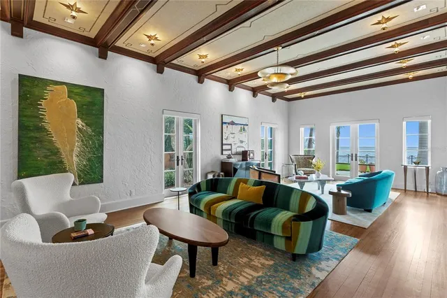 a room with round mirror and furniture