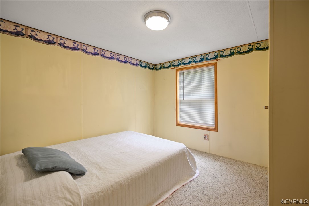 648 New Dragon Bridge Road Mascot, VA 23108 - Photo 14 of 43 a bedroom with a bed and a window