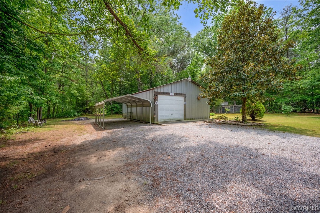 648 New Dragon Bridge Road Mascot, VA 23108 - Photo 20 of 43 a view of a house with backyard and trees