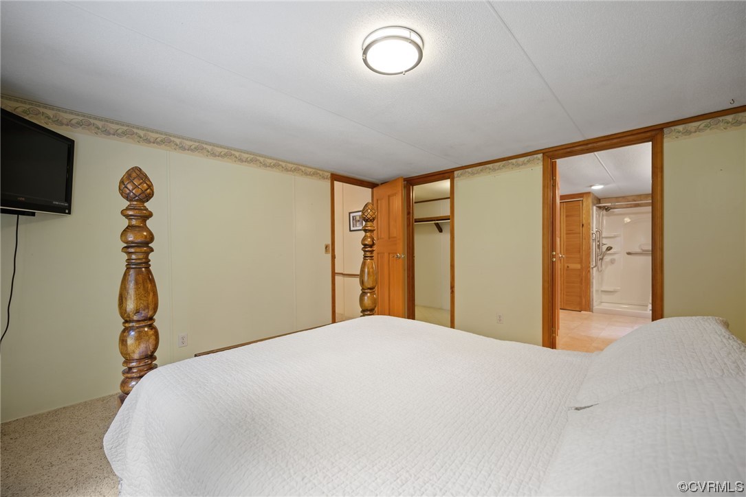 648 New Dragon Bridge Road Mascot, VA 23108 - Photo 10 of 43 a bedroom with a bed and a flat screen tv