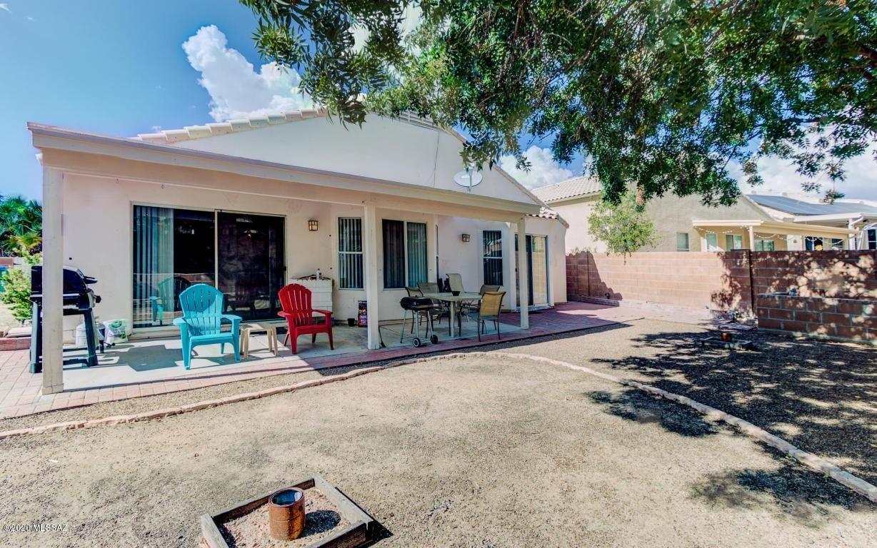5311 West Fireopal Way Tucson, AZ 85742 - Photo 14 of 14 a view of a patio with table and chairs and potted plants