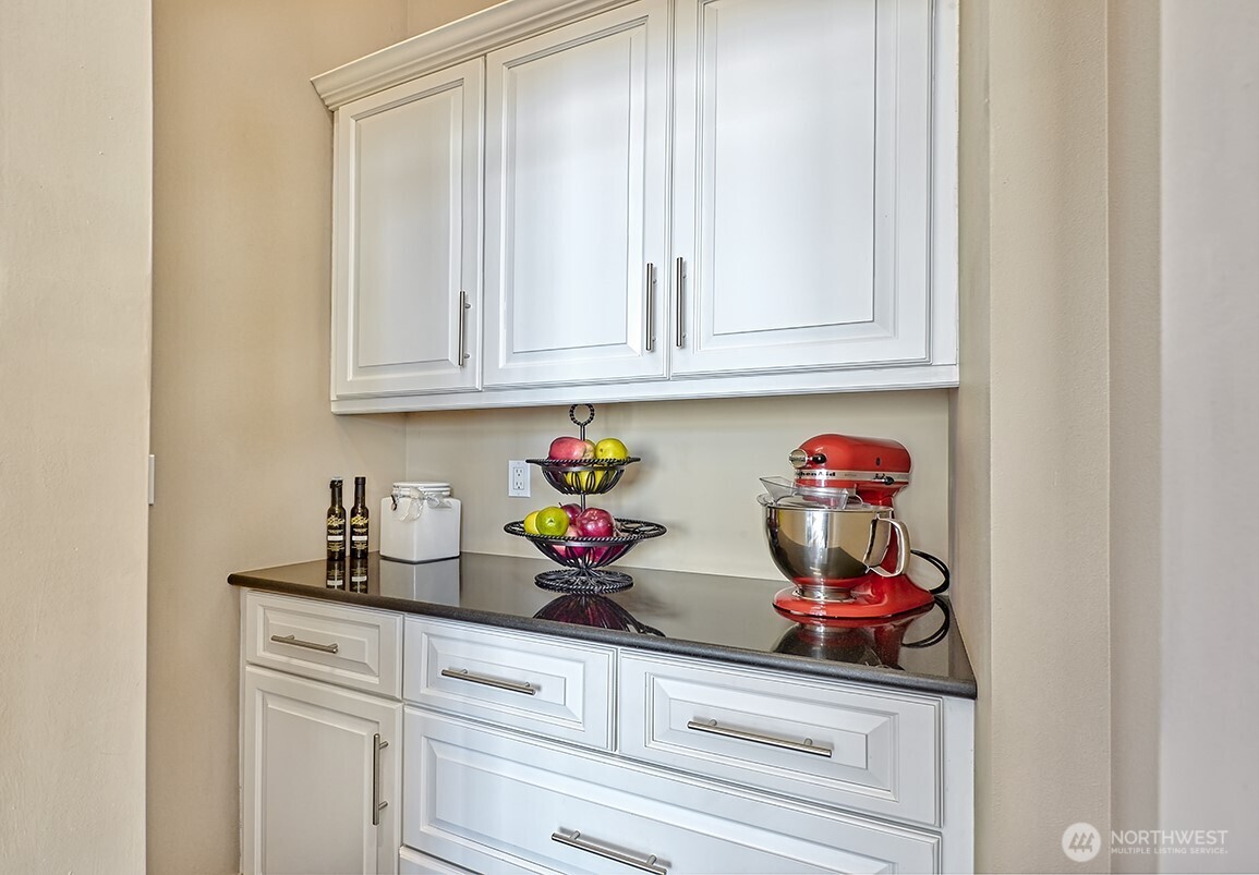 3042 North Shore Road Bellingham, WA 98226 - Photo 11 of 35 a kitchen with granite countertop white cabinets and utility room