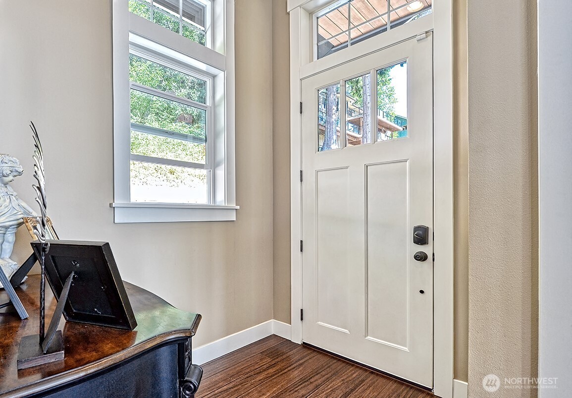 3042 North Shore Road Bellingham, WA 98226 - Photo 15 of 35 a view of a hallway to a livingroom with wooden floor and a window