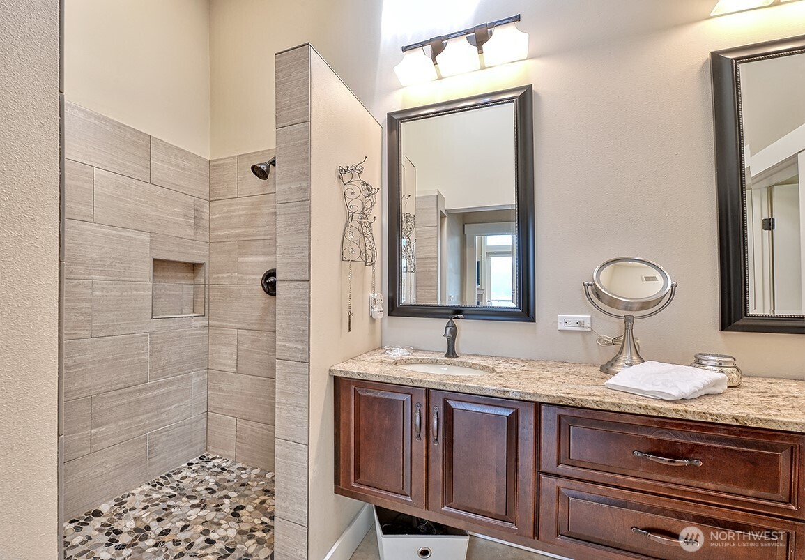 3042 North Shore Road Bellingham, WA 98226 - Photo 26 of 35 a bathroom with a granite countertop sink a mirror and shower
