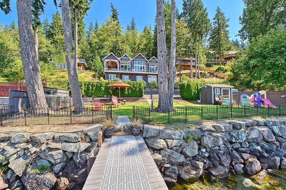 3042 North Shore Road Bellingham, WA 98226 - Photo 31 of 35 a view of a chairs and table in backyard of the house