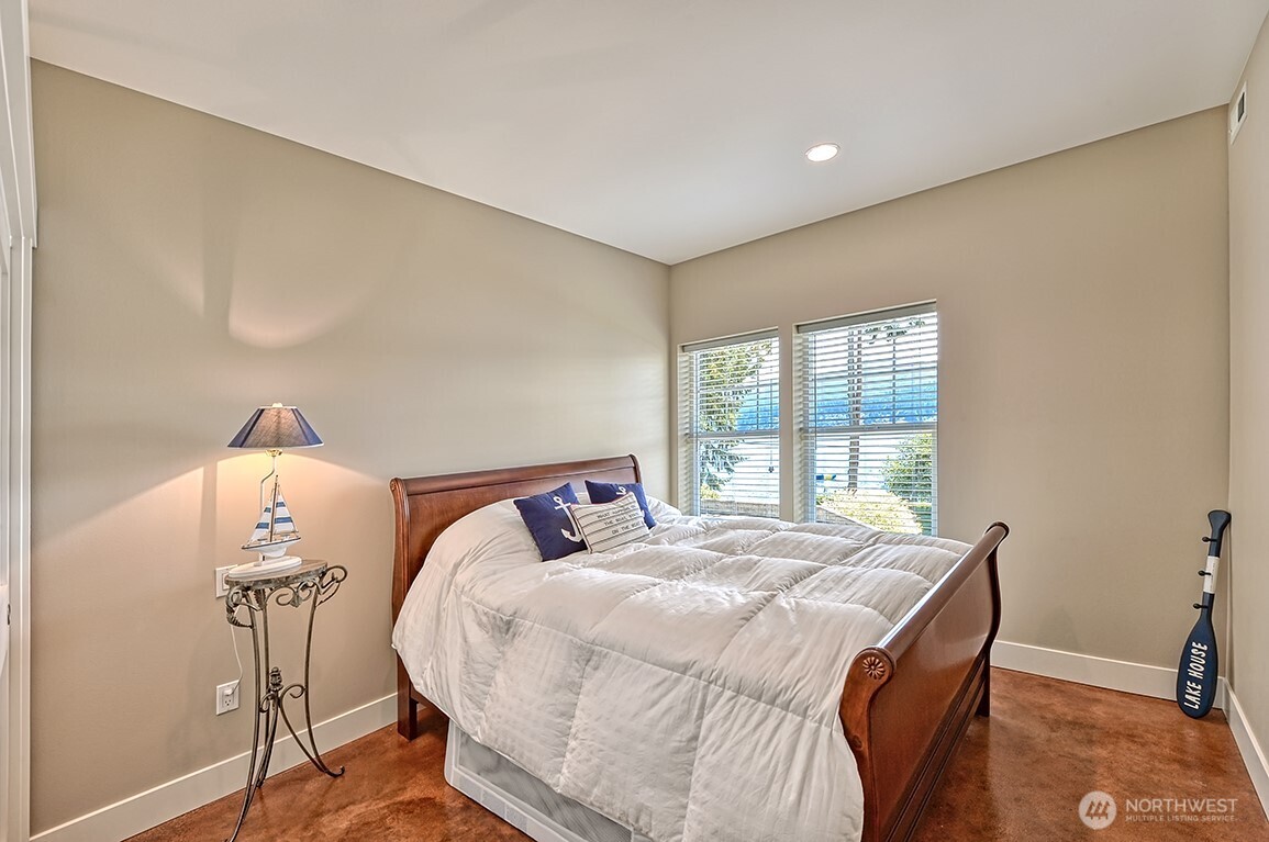 3042 North Shore Road Bellingham, WA 98226 - Photo 8 of 35 a bed sitting in a bedroom next to a window