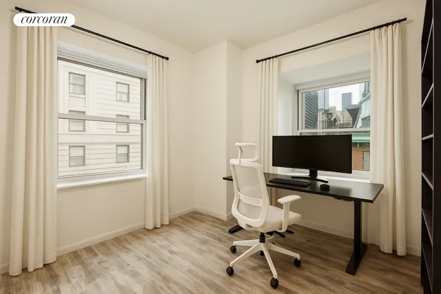 a bedroom with a large bed and wooden floor