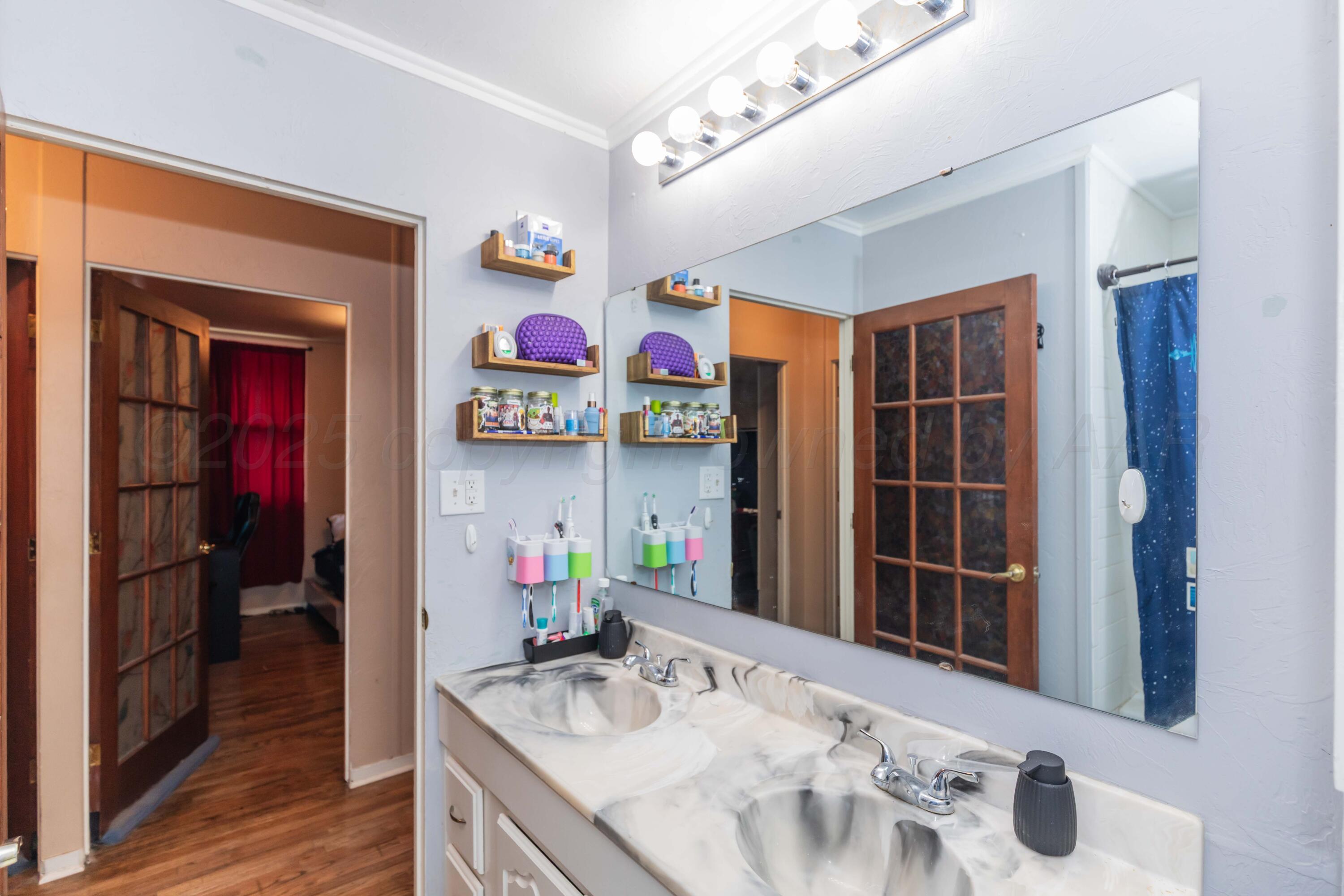 3609 Doris Drive Amarillo, TX 79109 - Photo 12 of 22 a bathroom with a sink mirror and vanity