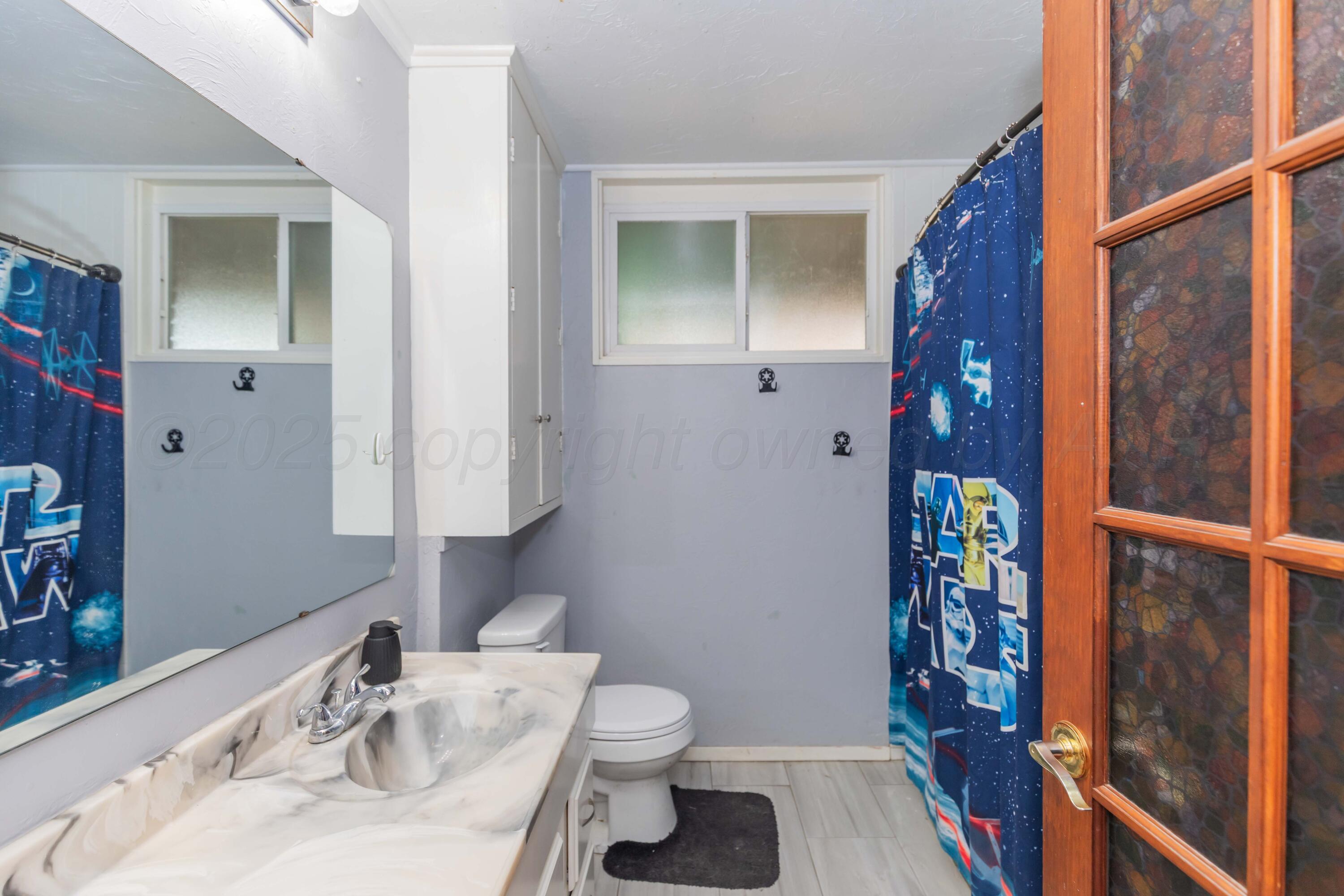 3609 Doris Drive Amarillo, TX 79109 - Photo 13 of 22 a bathroom with a sink toilet and shower