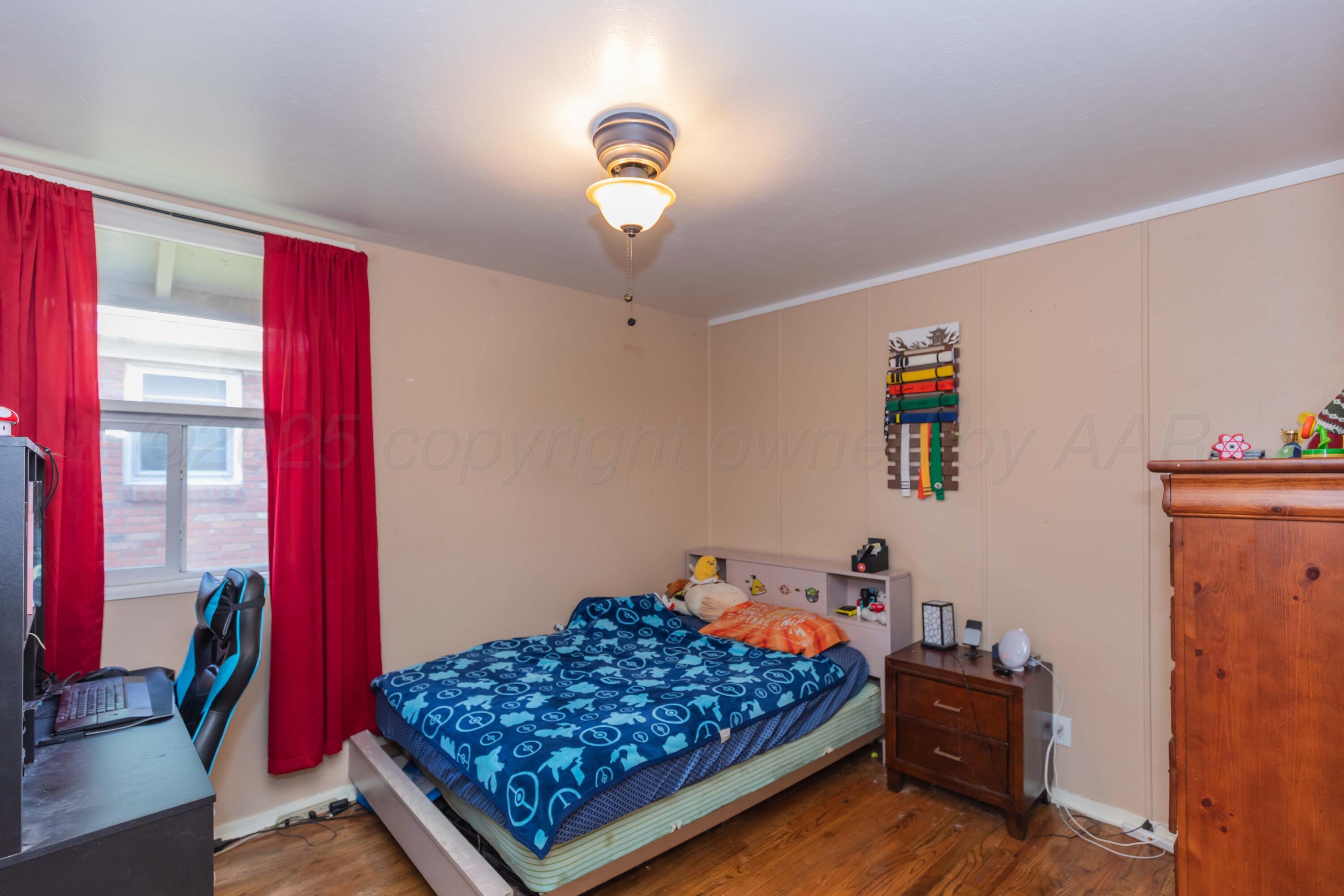 3609 Doris Drive Amarillo, TX 79109 - Photo 15 of 22 a bed room with a bed and a chandelier