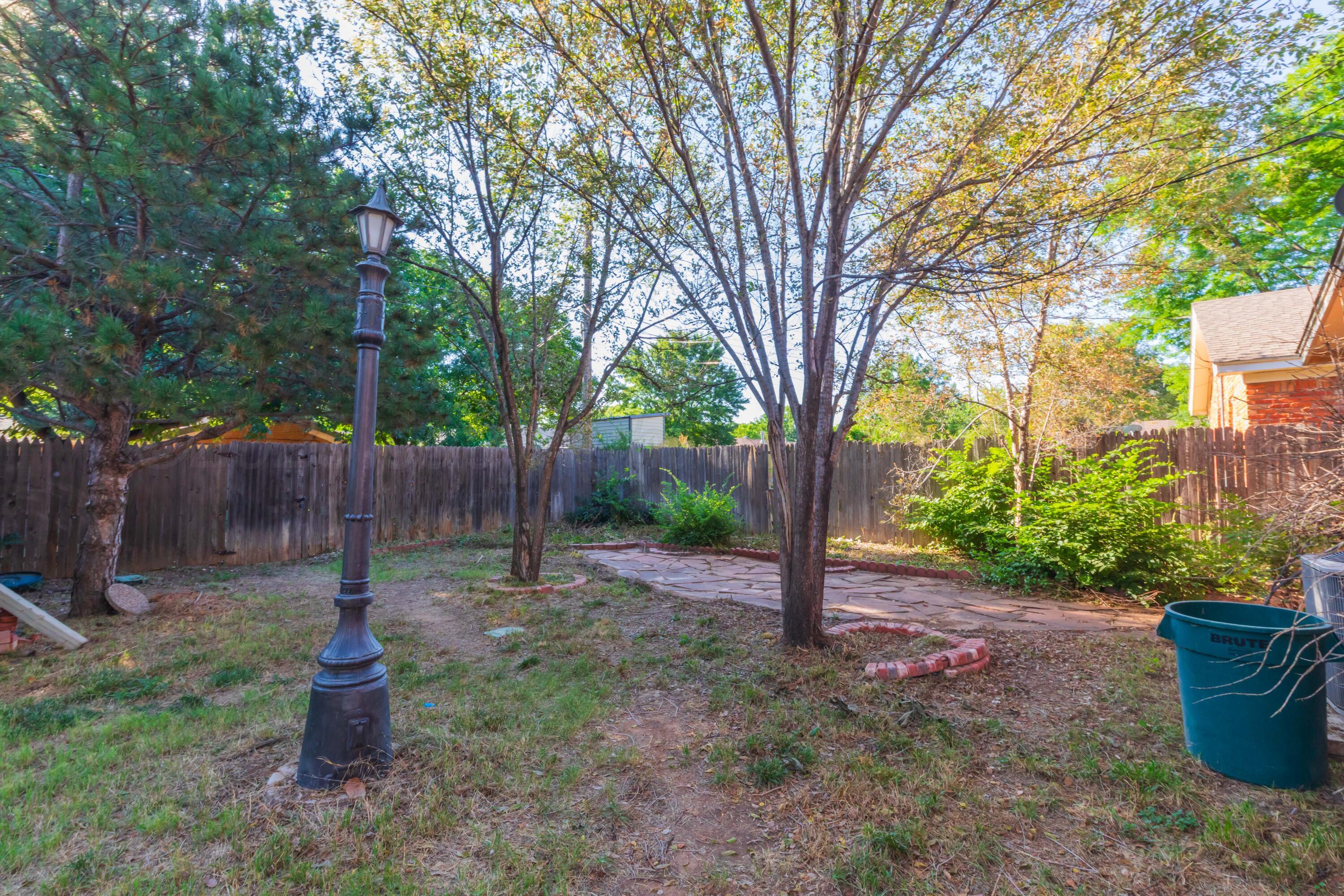 3609 Doris Drive Amarillo, TX 79109 - Photo 19 of 22 a park with large trees and a wooden fence