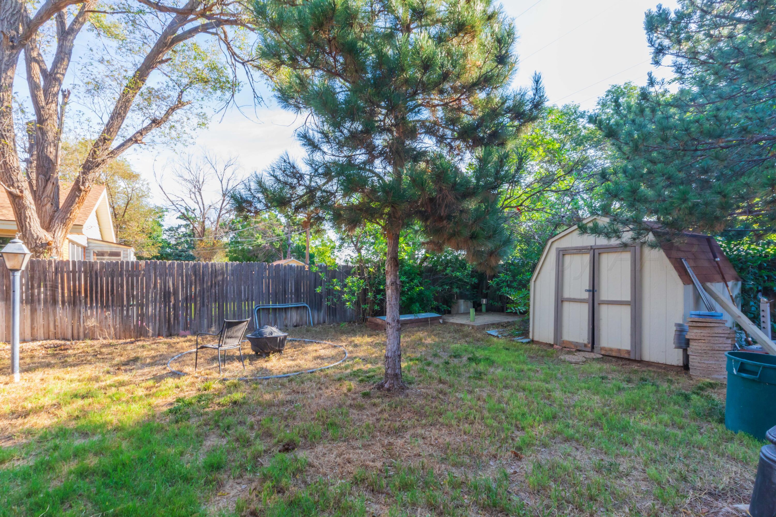 3609 Doris Drive Amarillo, TX 79109 - Photo 22 of 22 a view of a backyard with wooden fence and a large tree