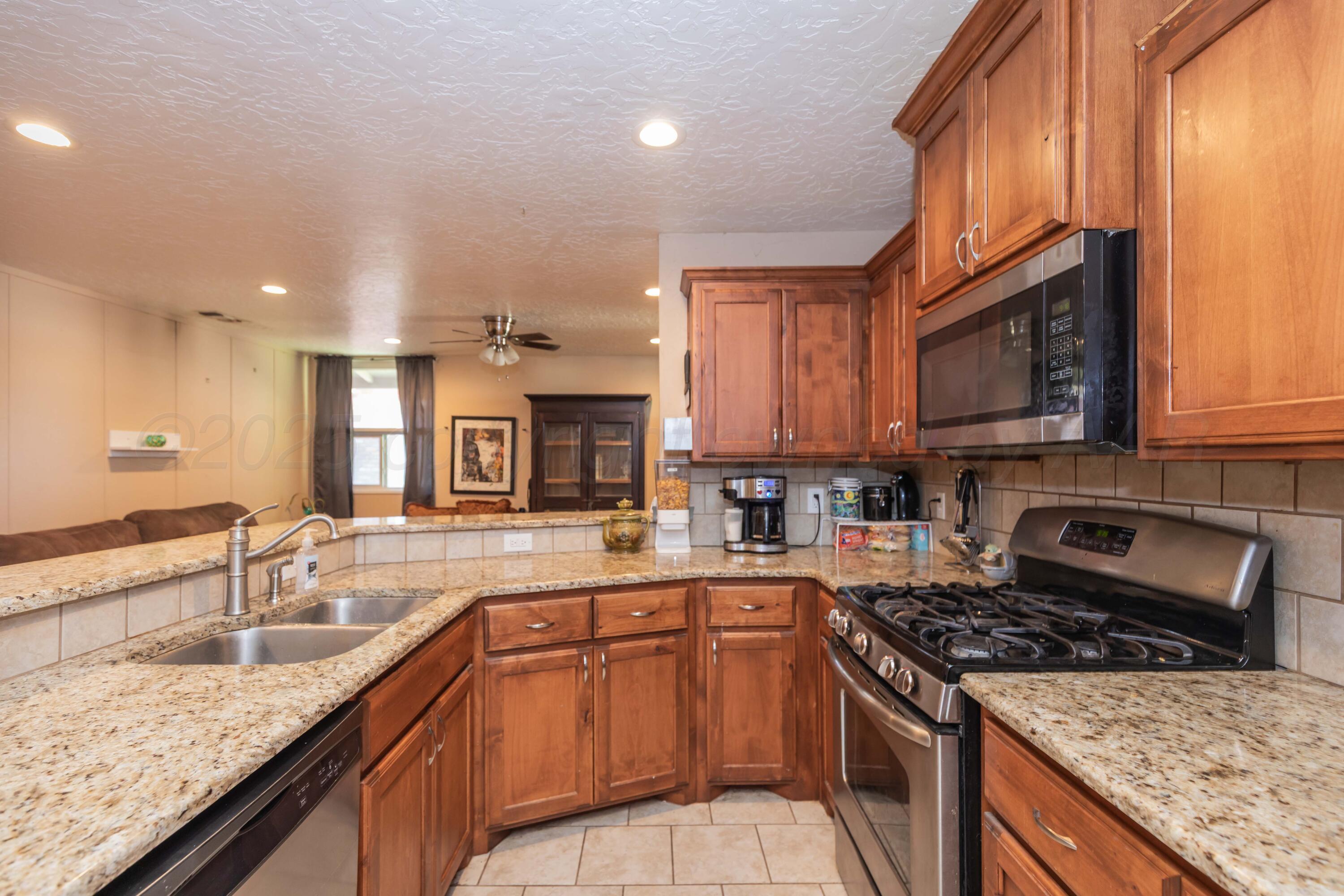 3609 Doris Drive Amarillo, TX 79109 - Photo 5 of 22 a kitchen with granite countertop stainless steel appliances and sink