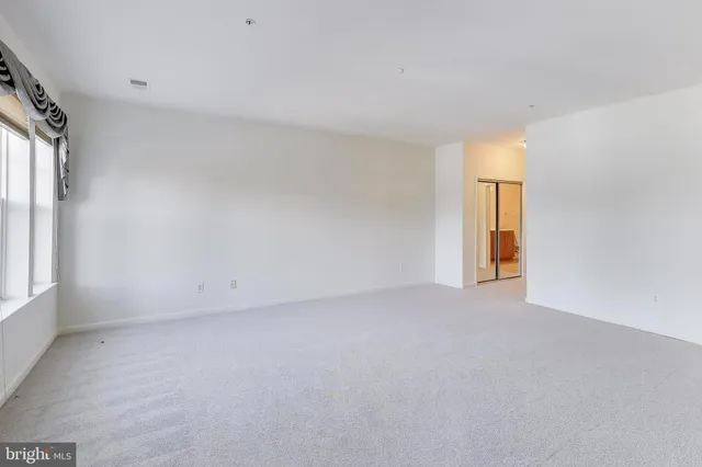 a view of an empty room and a window