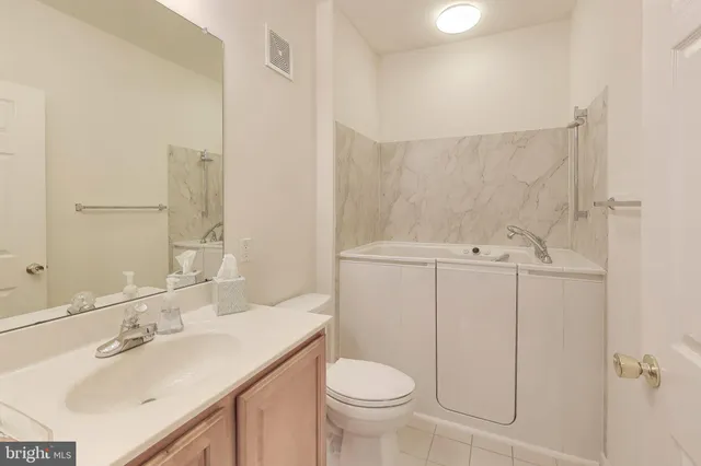 a bathroom with a sink toilet and vanity