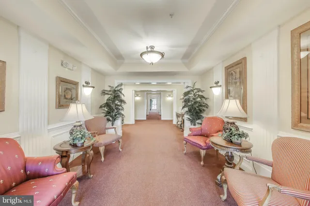 a living room with furniture and flowers