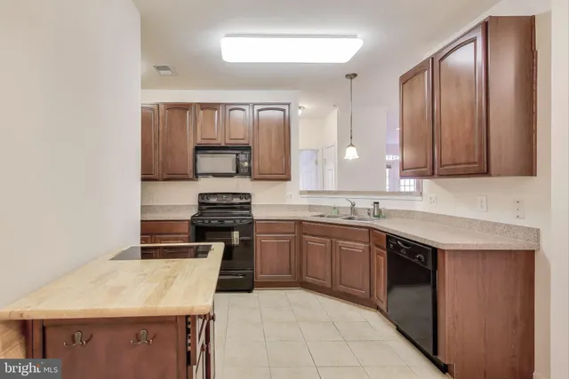 a kitchen with stainless steel appliances granite countertop a sink and stove top oven