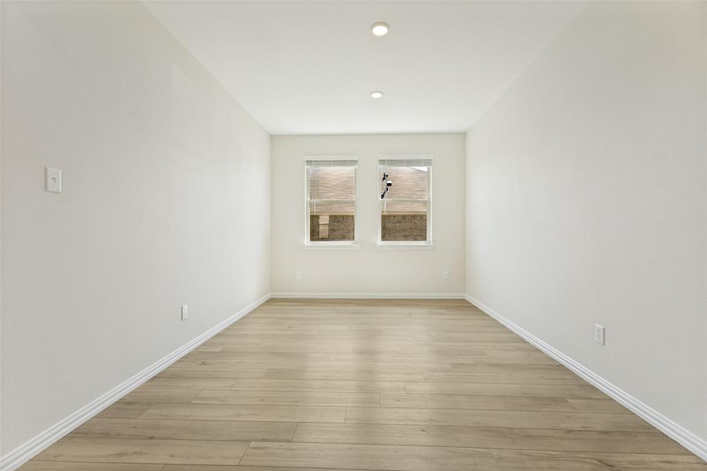 1237 Almond Road Azle, TX 76020 - Photo 14 of 24 an empty room with wooden floor and windows
