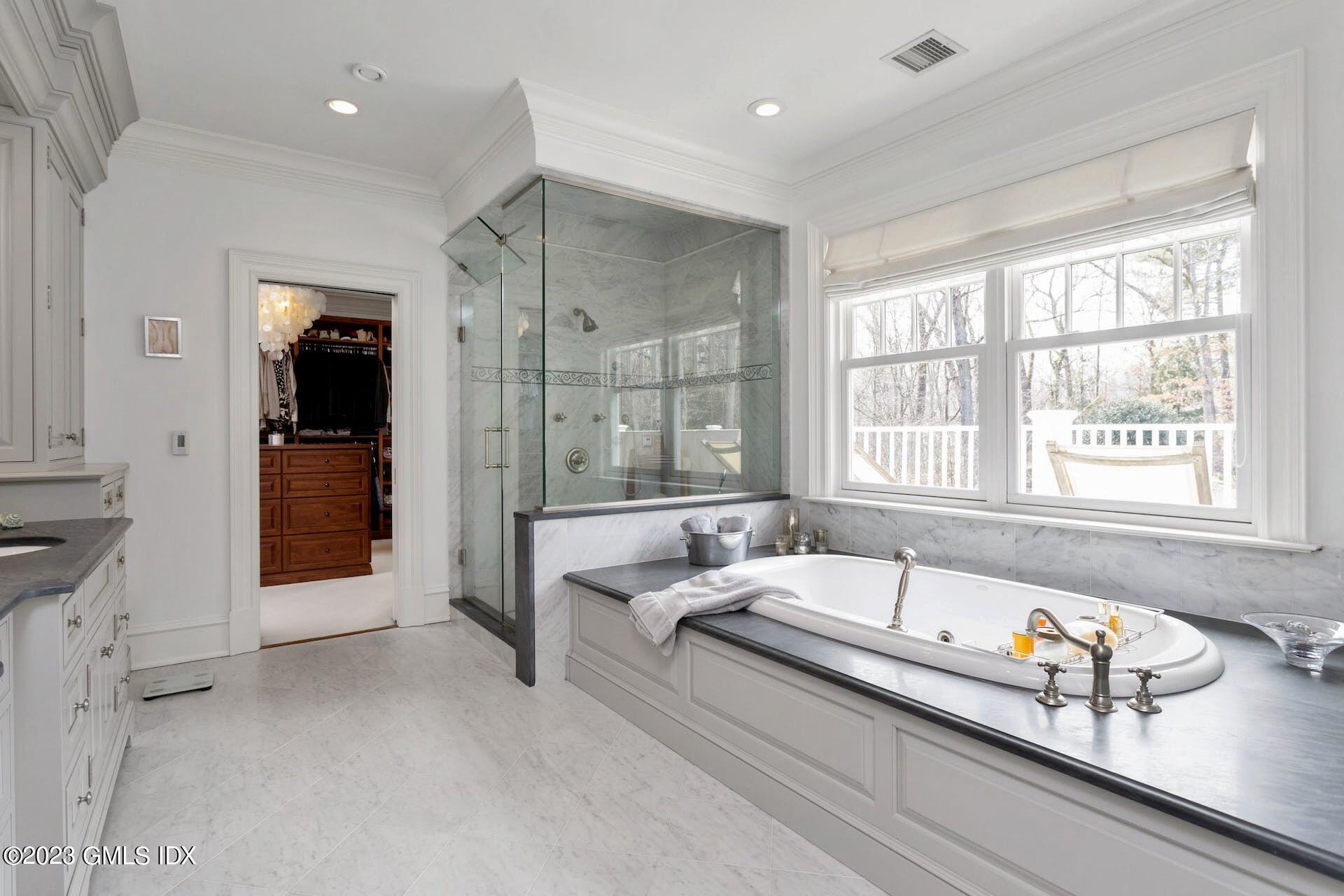 154 Cognewaugh Road Cos Cob, CT 06807 - Photo 18 of 46 a spacious bathroom with a bathtub and a shower